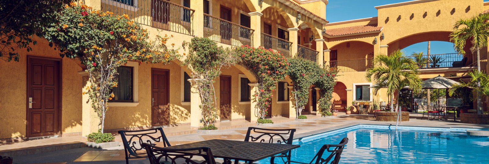 Traditional inner yard of a mexican mansion with a turquoise swimming pool