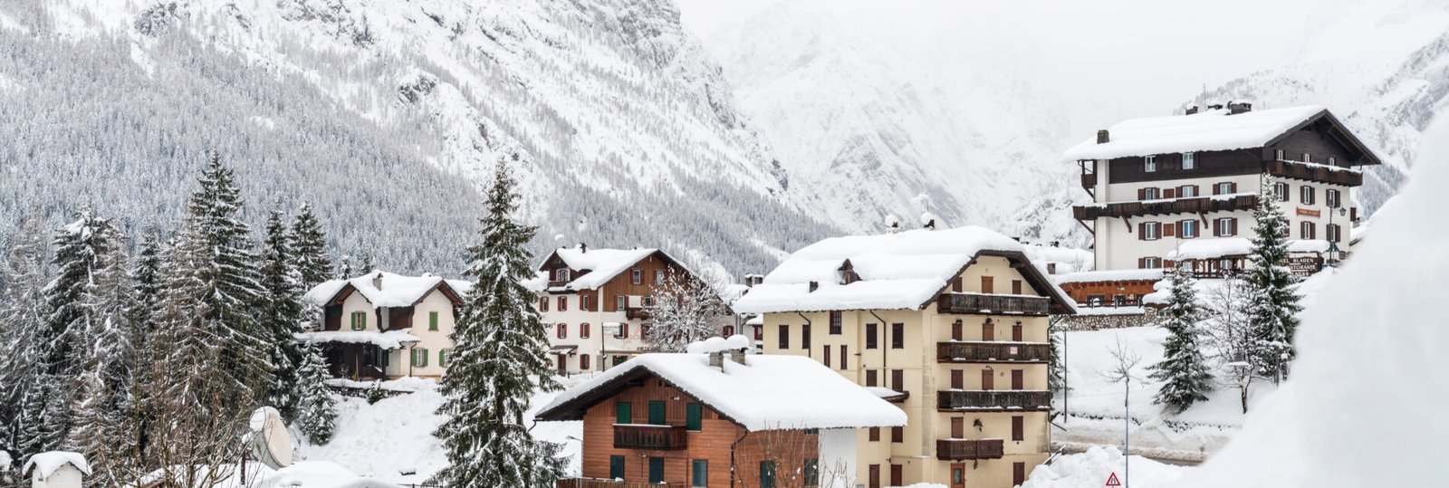 houses-snowcapped-mountains-against-sky